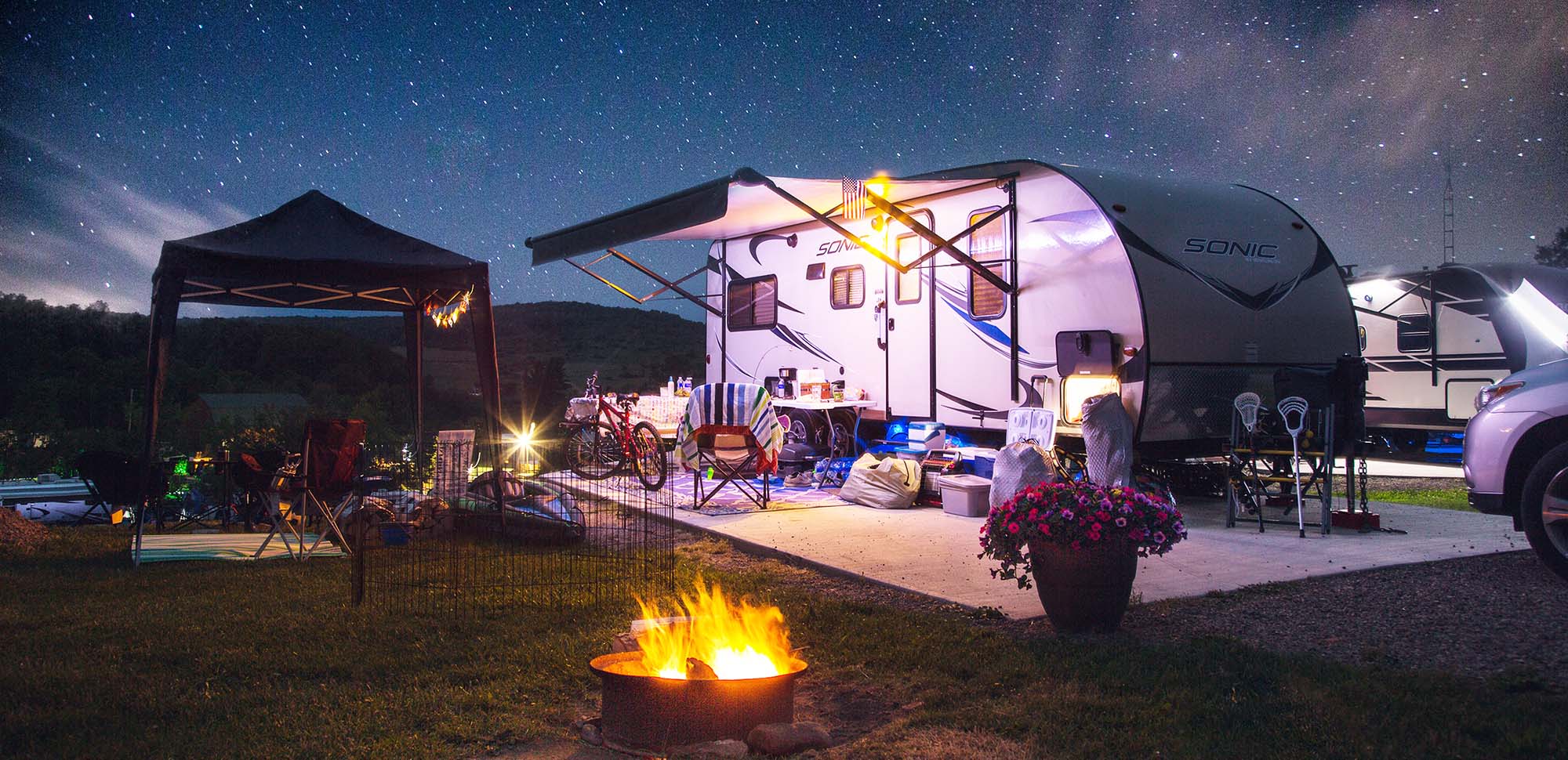 Caravan Finance nighttime with stars amd campfire banner option